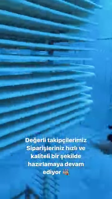 Raflarda üst üste dizilmiş geniş dekoratif paneller sergileniyor.