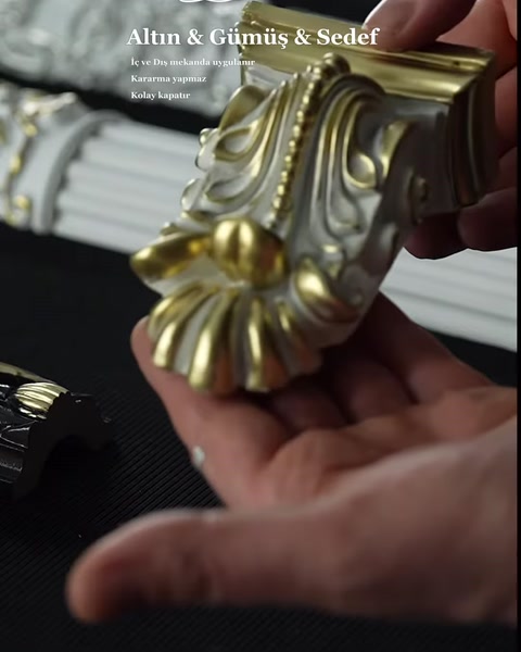 Altın ve gümüş tonlarla tamamlanan oyma sütun başlığı detayı
