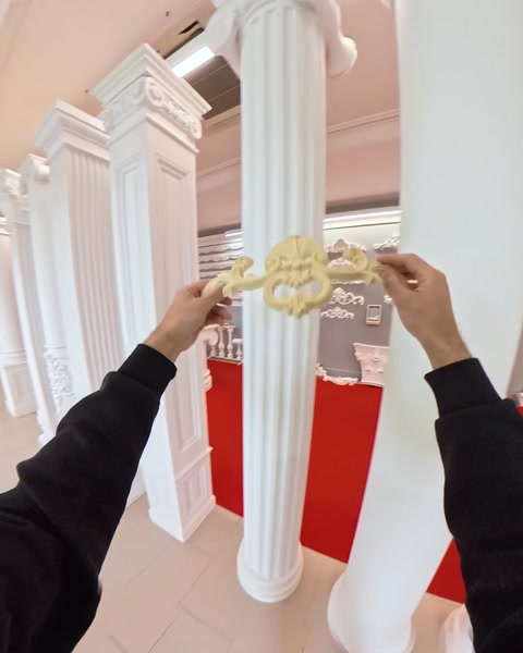 Altın renkli süs elemanı sütuna yerleştiriliyor