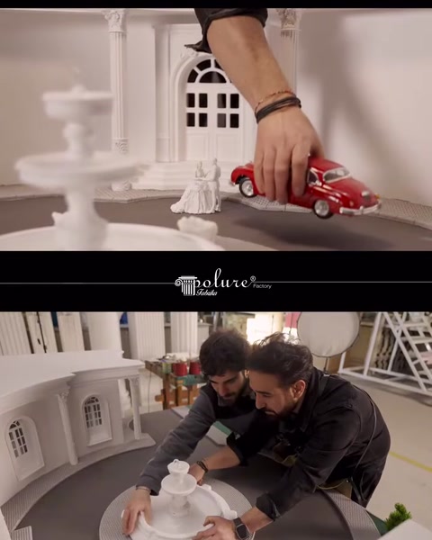 Kırmızı araç yerleştirilirken maket çevresinde ekip çalışıyor