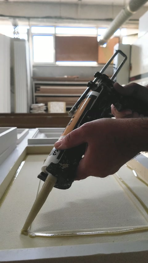 Panel yüzeyine çerçeve montajı için yapıştırıcı uygulanıyor.